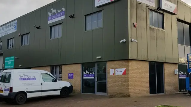 A veterinary office building displays signs reading