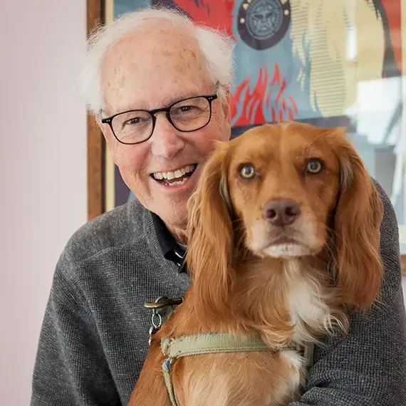 Dr Bruce Fogle cuddling a pet