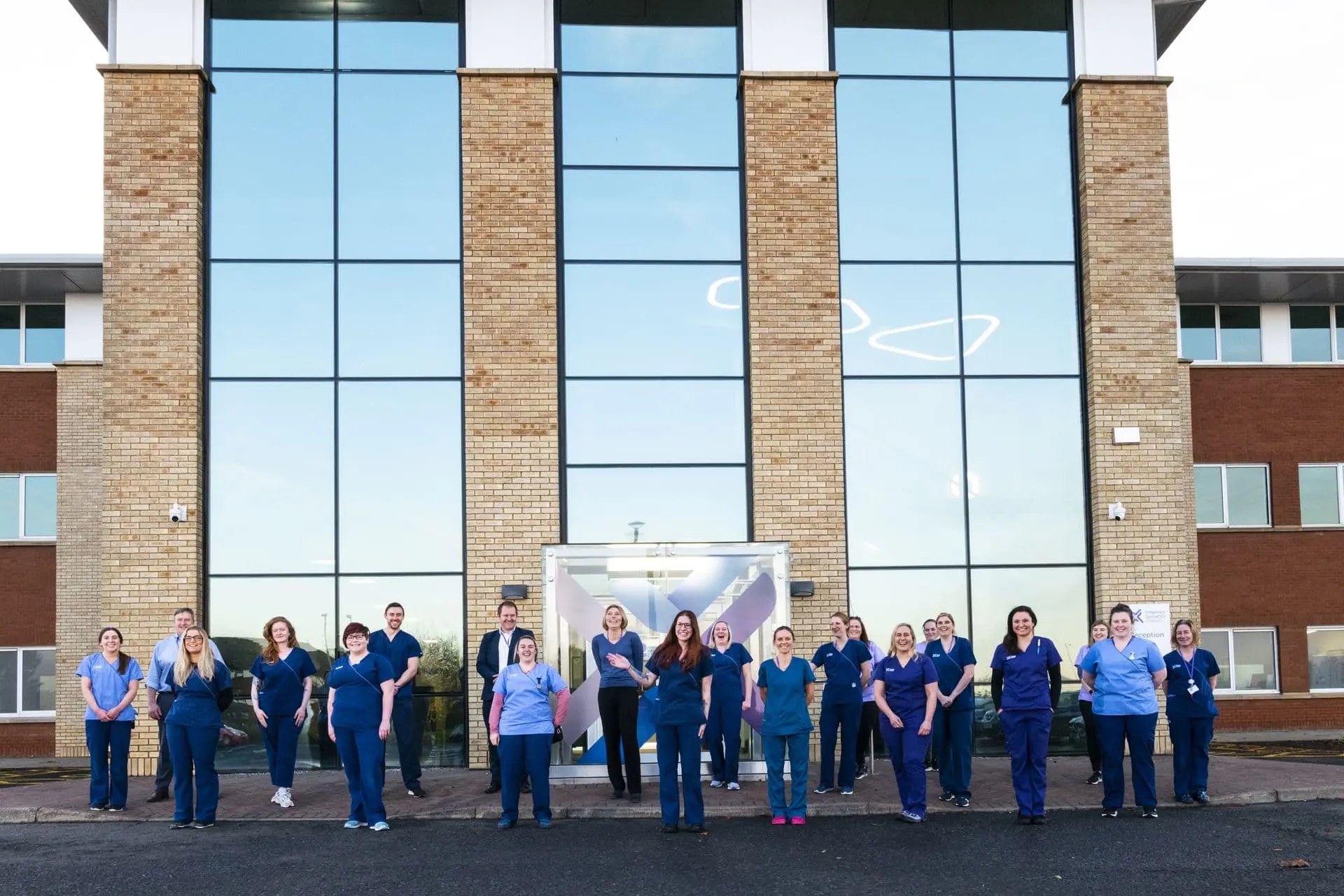 team standing outside VSS building in uniform